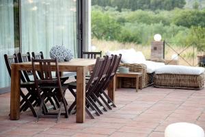 a wooden table and chairs on a patio at Mas del Molí in Reus