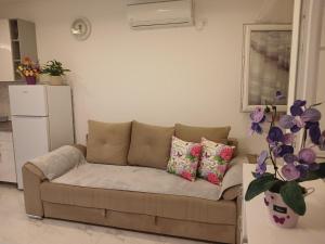 a living room with a couch and a refrigerator at Apartmani LaVa igalo 1 in Igalo