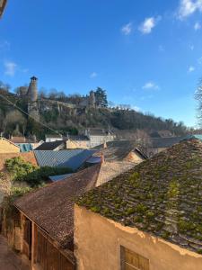 a town with ivy on the roofs of buildings at Beau studio proche des Halles in Crémieu