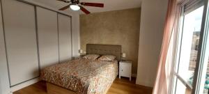 a bedroom with a bed and a ceiling fan at Mi casa en Almogia - Andalucia in Almogía +19 photos