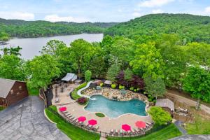 an overhead view of a pool with a resort and a lake at Luxury Lakefront Chalet Resort 2 Pools FREE Amenities Dock Kayaks Waterslide in Lampe