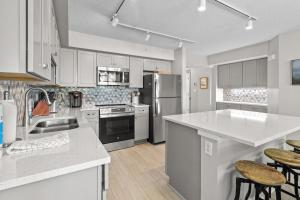 a kitchen with white cabinets and white counter tops at Beach and Golf Oceanfront 3 Bdrm Newly Renovated in Pawleys Island