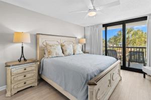a bedroom with a bed and a large window at Beach and Golf Oceanfront 3 Bdrm Newly Renovated in Pawleys Island +20 photos