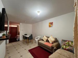 a living room with a couch and a table at Palmeras house in Ica