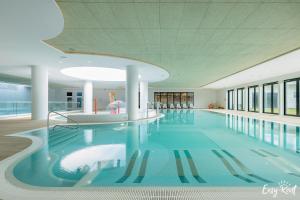 a large swimming pool in a building at Prestige 103 - z widokiem na morze - BASEN, sauna, jacuzzi w cenie pobytu! - Easy - Rent Apartments in Pobierowo