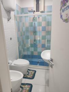 a bathroom with a shower and a toilet and a sink at Annyhouse via litoranea 38 in Torre del Greco +16 photos