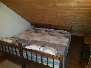 a bed in a room with a wooden ceiling at Ozon in Belgrade +17 photos
