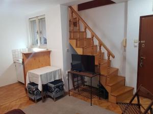 a living room with a staircase with a television at Ozon in Belgrade