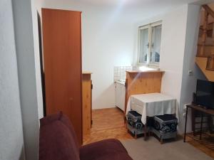 a living room with a couch and a table and a window at Ozon in Belgrade