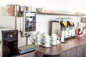 a counter in a kitchen with a coffee machine at Best Western Plaza Hotel Mannheim in Mannheim