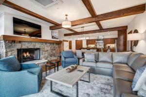 a living room with couches and a fireplace at Bachelor Gulch Village by Vail Resorts in Avon