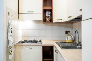 a kitchen with white cabinets and a stove top oven at Villa Casa Marina in Castiglioncello +68 photos