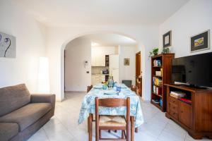 a living room with a table and a couch at Villa Casa Marina in Castiglioncello