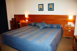 Cama ou camas em um quarto em Hotel das Taipas