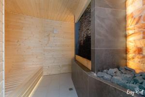 a bathroom with a sauna with wooden walls at Prestige 204 - tuż przy plaży - Easy-Rent Apartments in Pobierowo