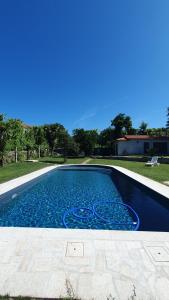 a swimming pool with blue water in a yard at Quinta de Ramil in Vieira do Minho
