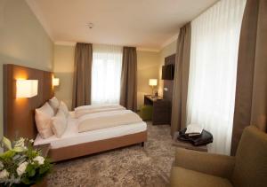 Postel nebo postele na pokoji v ubytování Hotel Jakob Regensburg DownTown, Best Western Signature Collection