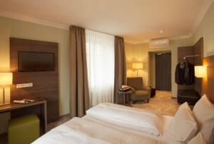 Postel nebo postele na pokoji v ubytování Hotel Jakob Regensburg DownTown, Best Western Signature Collection