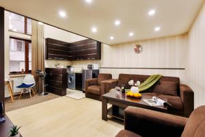 a living room with a couch and a table at Residence North Avenue, small center in Yerevan +17 photos