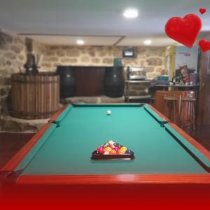 a pool table with a ball on top of it at Quinta de Ramil in Vieira do Minho
