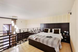 a bedroom with a large bed and a balcony at Residence North Avenue, small center in Yerevan
