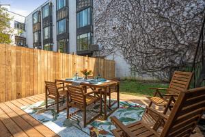a wooden table and chairs on a patio at Luxury Old Montreal Parking with Yard Patio 10 Guests in Montréal