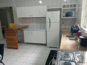a kitchen with a refrigerator and a stove in it at Apartamento iluminado SLP! in São Luiz do Paraitinga +10 photos