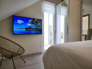 a bedroom with a bed and a tv on the wall at Beach Apartments Old Town in Estepona
