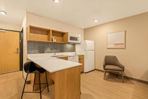 a kitchen with a sink and a refrigerator at LivAway Suites Nashville-Smyrna in Smyrna +20 photos