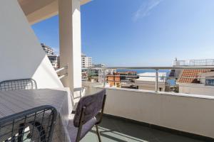 a balcony with a table and chairs and a view at Apartments Monte in Ulcinj