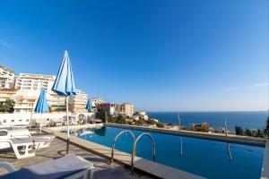 a swimming pool with a view of the ocean at Apartments Monte in Ulcinj