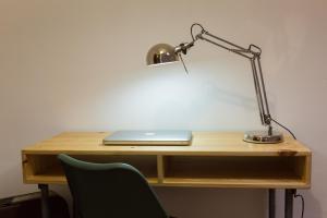a desk with a laptop and a lamp on it at Casa Joaninha in Aljustrel