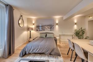 a bedroom with a bed and a table with chairs at Renovated Apartment Saint-Germain-des-Prés - Le Bon Marché in Paris