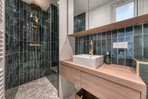 a bathroom with a sink and a shower at Renovated Apartment Saint-Germain-des-Prés - Le Bon Marché in Paris +19 photos