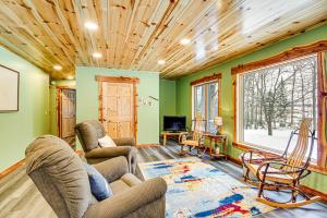 a living room with green walls and a wooden ceiling at Pokegama Lake Vacation Rental with Shared Boat Dock! in Grand Rapids