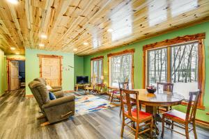a living room with green walls and a wooden ceiling at Pokegama Lake Vacation Rental with Shared Boat Dock! in Grand Rapids