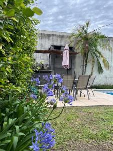 a garden with purple flowers and a table and chairs at Casa Antigua in San Francisco