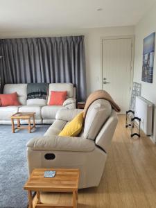 a living room with a couch and a table at Southern Beauty in Luggate