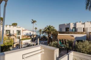 a view from the balcony of a building with palm trees at MiFlow Hotel Villas & Suites in Miami Platja