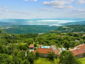 an aerial view of a house with trees and a lake at Villa Green Garden - Infinity Pool, Jacuzzi, Sauna and Panoramic Sea View in Hreljin