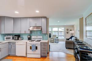 a kitchen with white appliances and a living room at Cozy Home Sleeps 10 Lombard Chicago Suburb in Lombard
