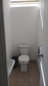 a white bathroom with a toilet and a sink at ROOMS for rent in Mexico City
