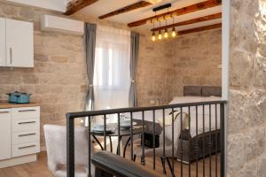 a room with a balcony with a table at Apartment Villa IV in Trogir
