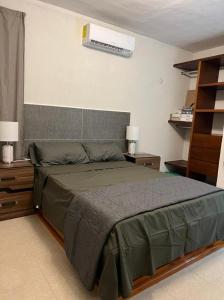 a bedroom with a bed and a air conditioner on the wall at Casa San Isidro in Valladolid +48 photos