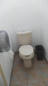 a bathroom with a toilet and a trash can at ROOMS for rent in Mexico City