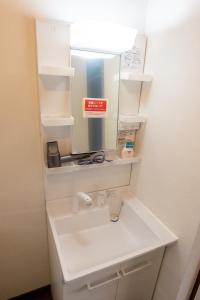 a bathroom with a sink and a mirror at lol 3 101 in Hakodate +14 photos