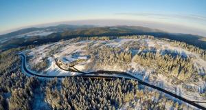 an aerial view of a road on a snow covered mountain at Wellness-& Nationalpark Hotel Schliffkopf, BWSC in Baiersbronn