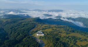 an aerial view of a house in the middle of a forest at Wellness-& Nationalpark Hotel Schliffkopf, BWSC in Baiersbronn