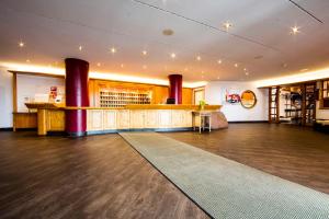 a large room with a bar and a dance floor at Wellness-& Nationalpark Hotel Schliffkopf, BWSC in Baiersbronn +141 photos