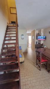 a staircase in a room with a living room at Duplex familiar 3 ambientes in San Bernardo